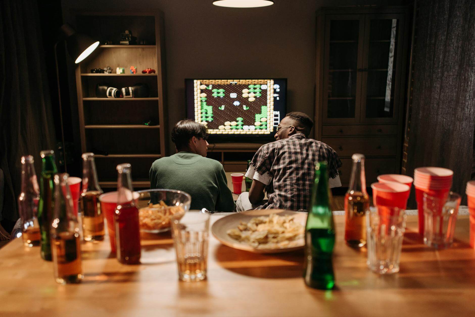 persons sitting in front of screen with game